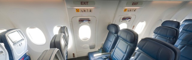 Main Cabin seats in the emergency exit rows inside a Boeing 737-900ER (739). 